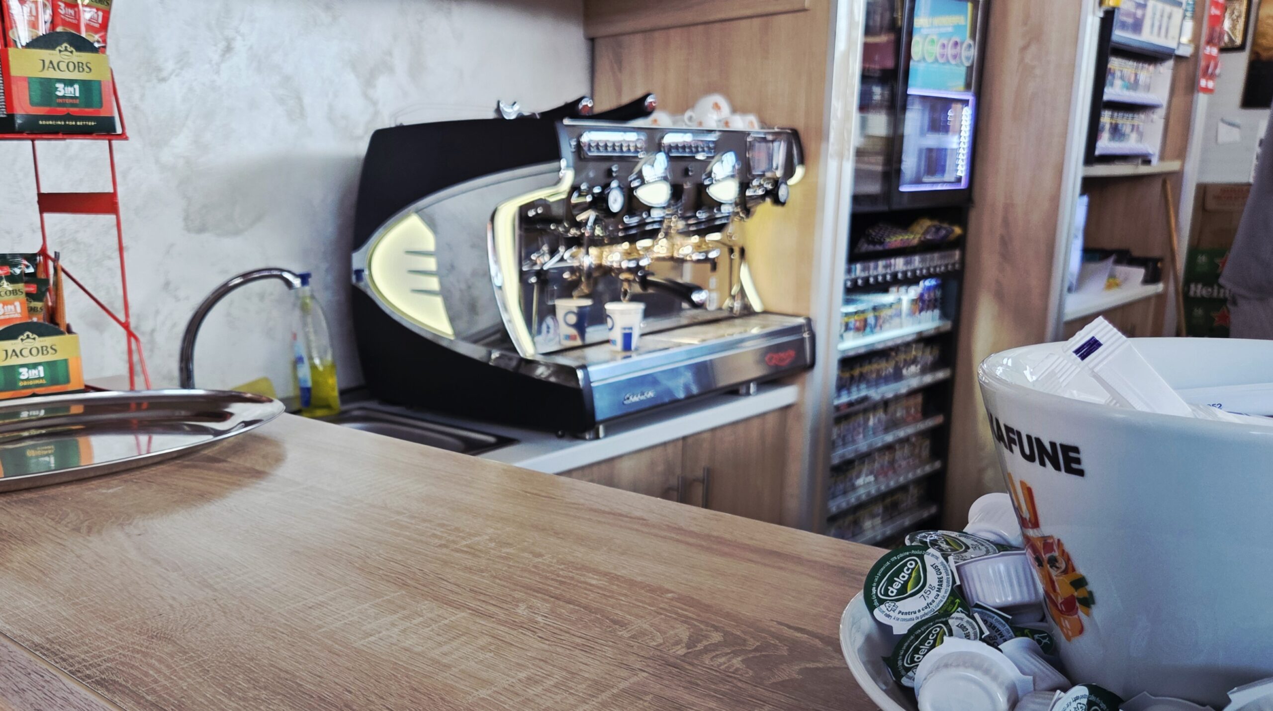 A large chrome espresso machine behind a café counter